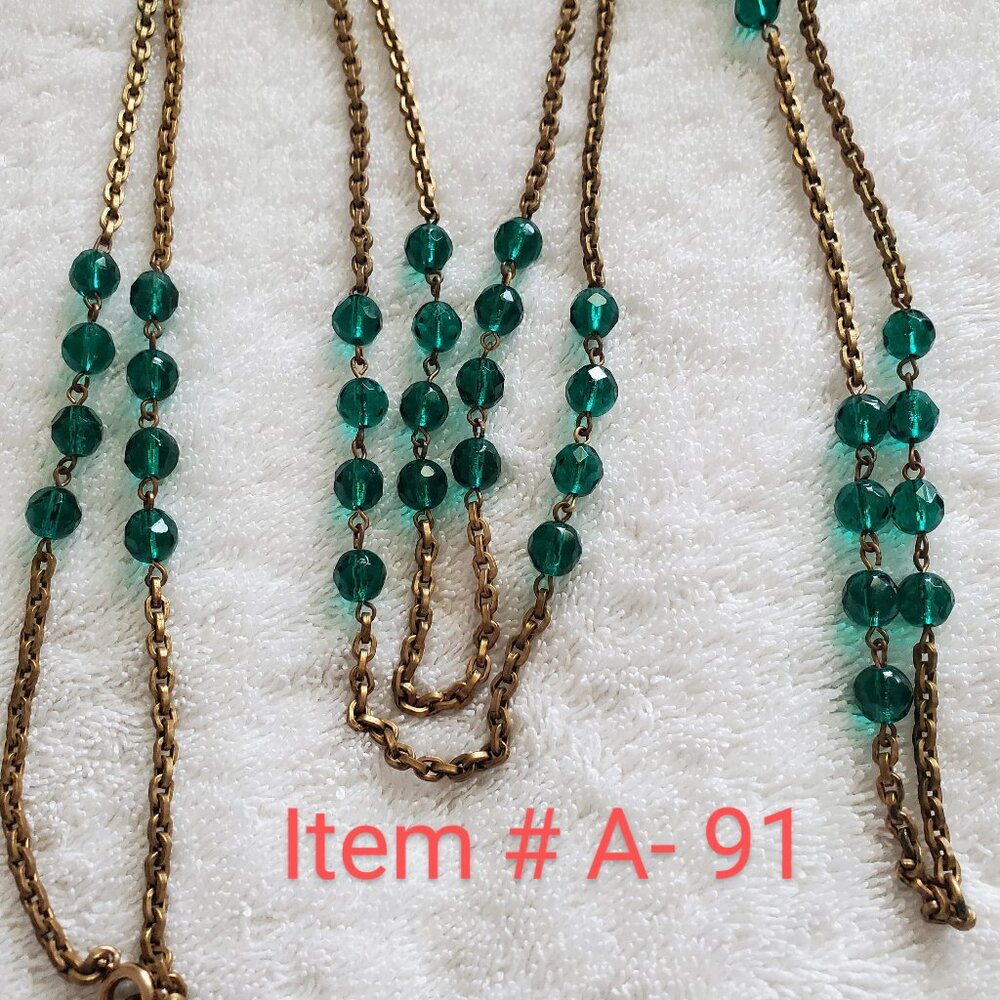 A long green gem gold necklace, wt. 63 grams, item #A-91